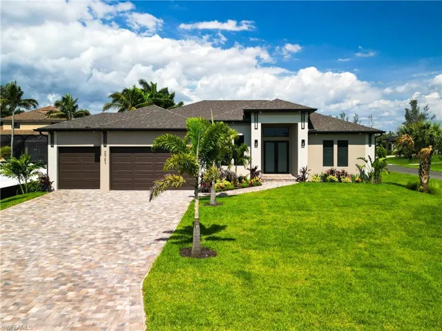 Prairie-style home featuring a garage and a front yard