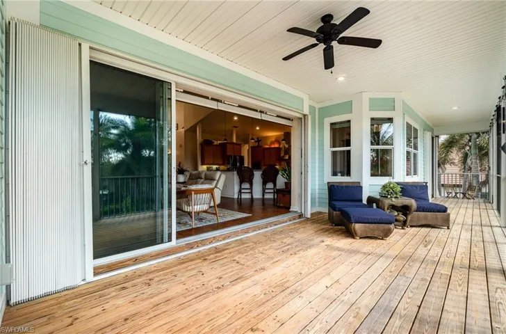 Wooden terrace featuring ceiling fan