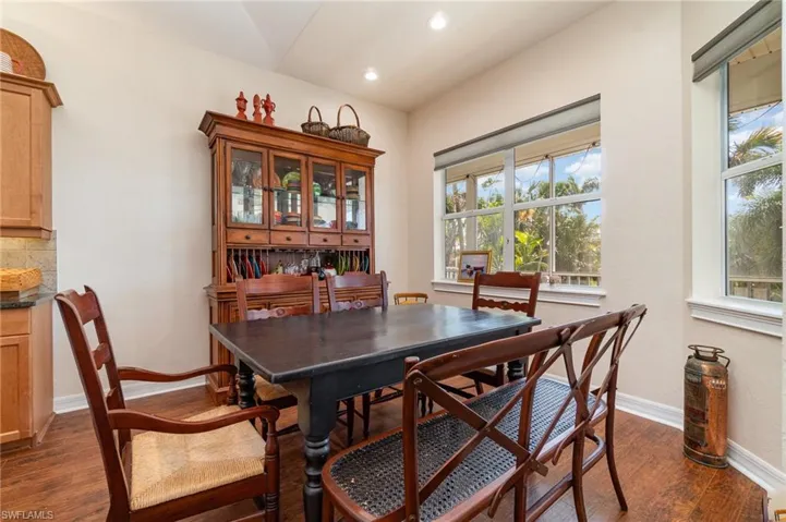 Dining area featuring baseboards, recessed lighting, and dark wood-type flooring