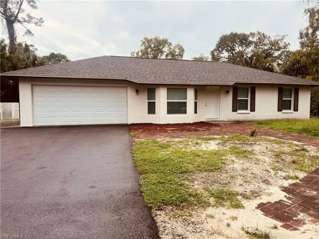 Ranch-style house featuring a garage
