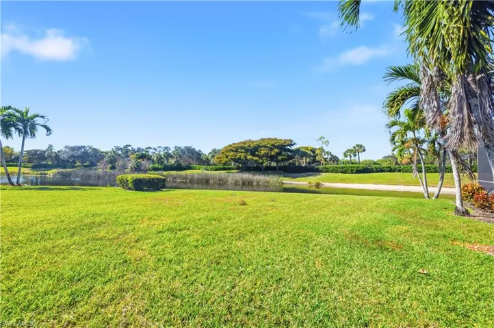 View of green lawn with a water view