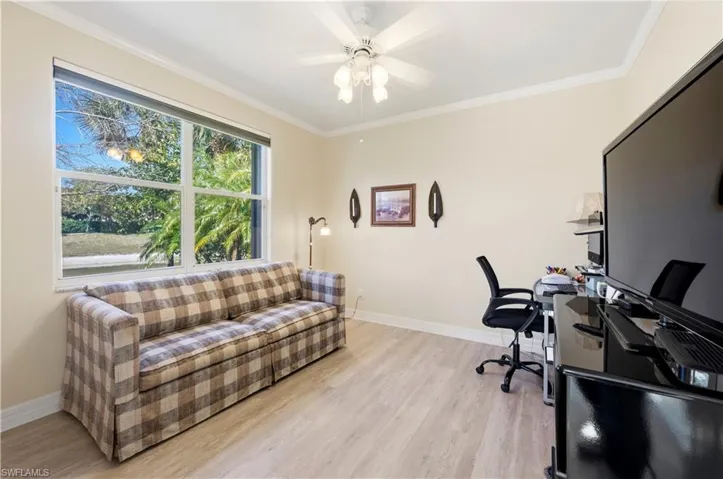 Office featuring ornamental molding, light wood-type flooring, and ceiling fan