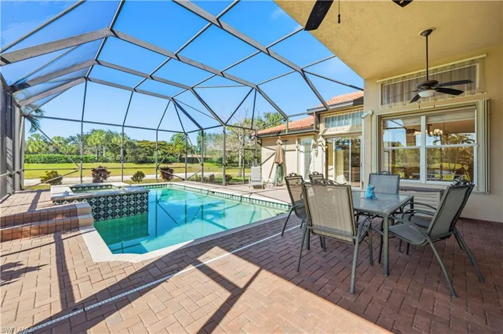 Integrated pool / spa featuring a sunroom, a patio, glass enclosure, and outdoor dining area
