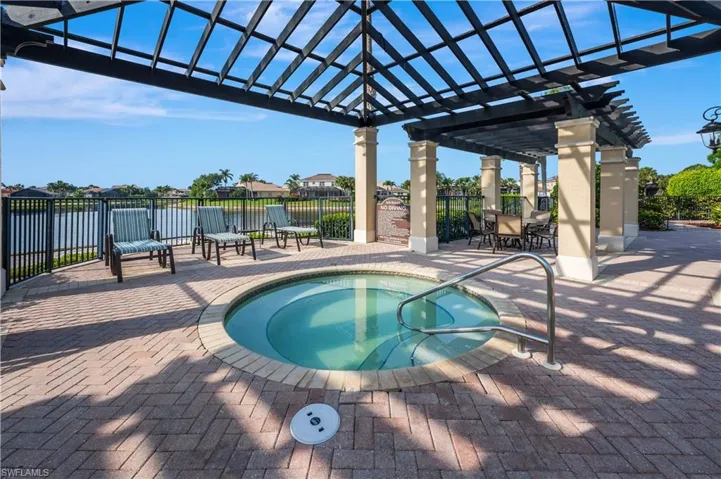 View of swimming pool with a pergola, patio surround, a swimming pool, outdoor dining area, and a water view