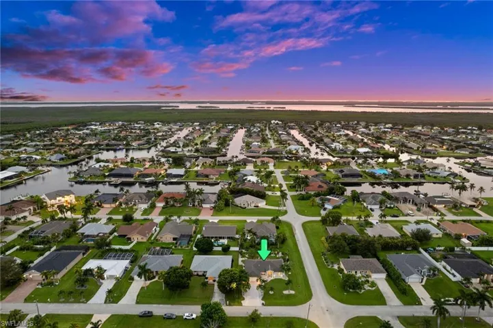 Aerial view at dusk featuring a water view