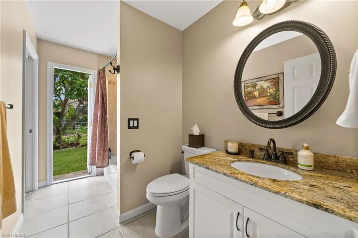 Guest Bathroom with bath tub and entrance to backyard