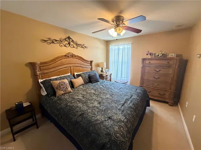 Bedroom featuring light carpet and ceiling fan