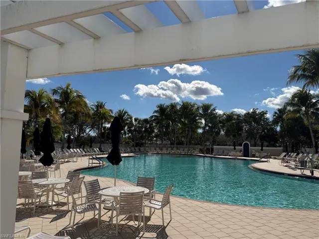 Community pool with a patio