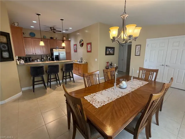 Dining room with a chandelier, recessed lighting, and light tile patterned flooring
