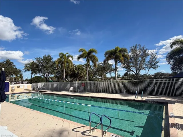 Community pool with a patio