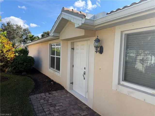 View of exterior entry with stucco siding