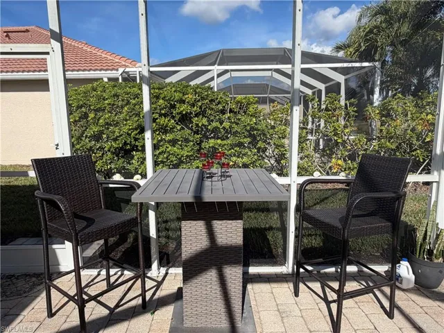 View of patio / terrace featuring glass enclosure, a sunroom, and outdoor dining area
