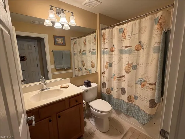 Bathroom featuring light tile patterned floors and vanity