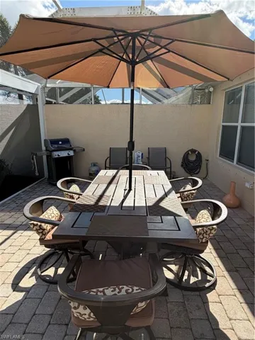 View of patio featuring a grill and outdoor dining space