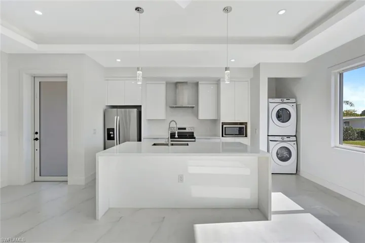 Living room and kitchen are open to one another.