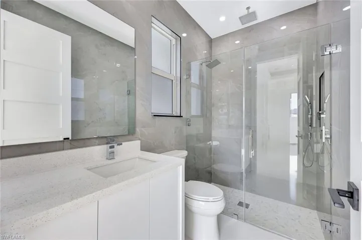 Ensuite primary bathroom features a large walk-in shower multiple shower heads.
