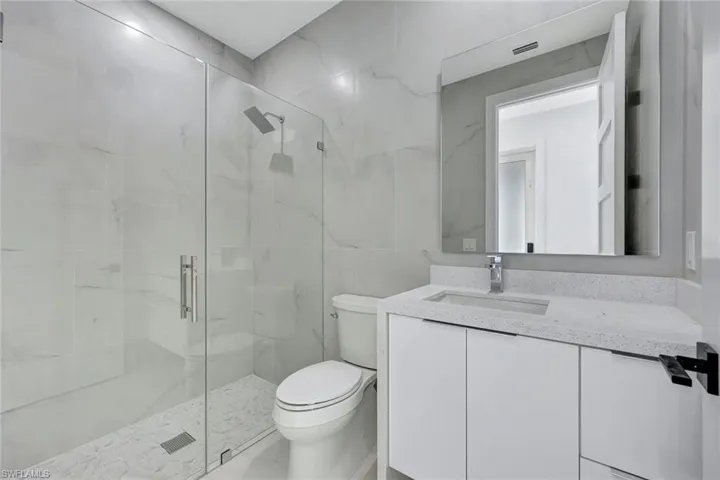 Guest bathroom features a walk-in shower.