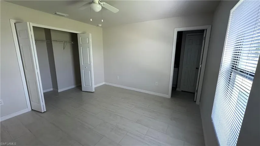 Unfurnished bedroom featuring a closet and a ceiling fan