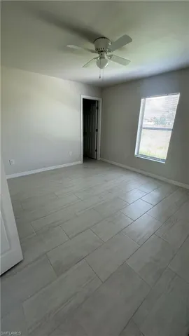 Empty room with baseboards and ceiling fan