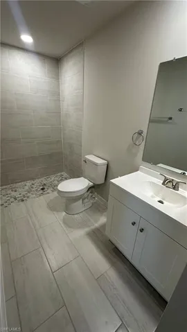 Full bath with vanity and a stall shower