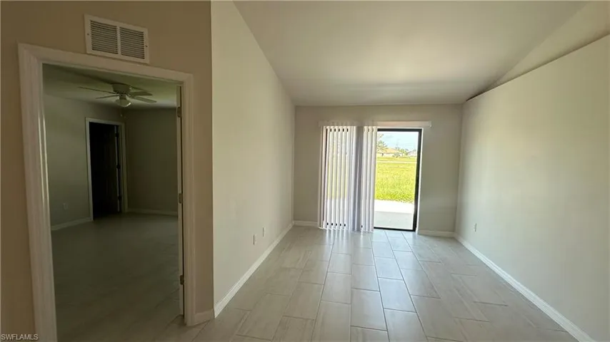 Empty room with wood tiled floors and a ceiling fan