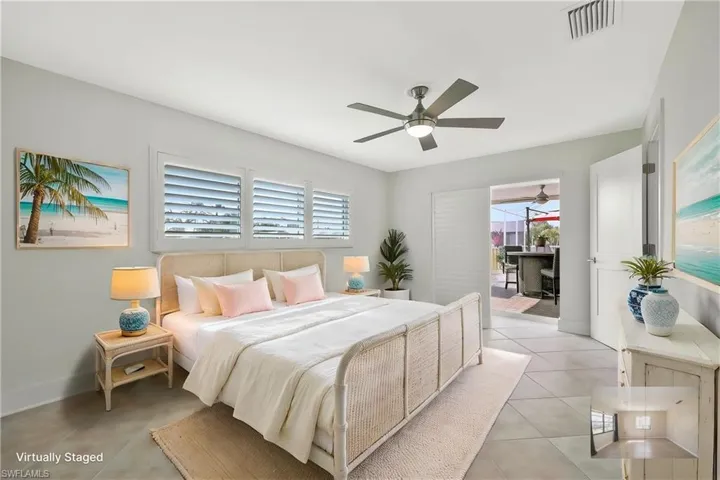 Bedroom with visible vents, baseboards, multiple windows, and light tile patterned floors