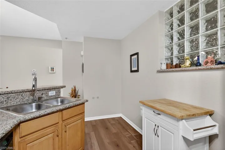Kitchen with dark wood-style floors and butcher block counters