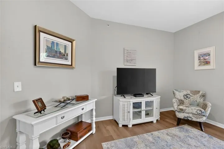 Living area featuring light wood-style floors and baseboards