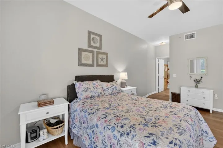 Bedroom featuring a ceiling fan and dark wood-style floors