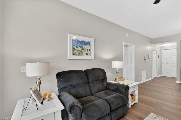 Living area featuring wood finished floors and a ceiling fan
