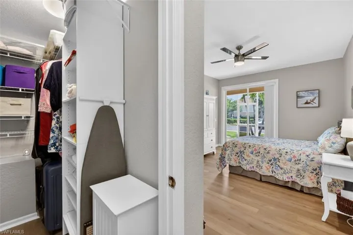 Bedroom with access to outside, light wood-style floors, and ceiling fan