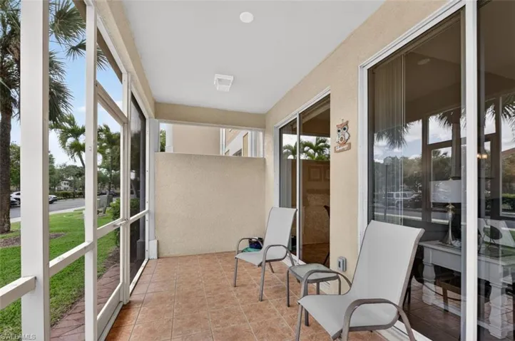 Sunroom / solarium with plenty of natural light and tile patterned flooring