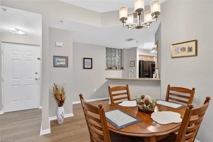 Dining area featuring light wood-type flooring and a chandelier