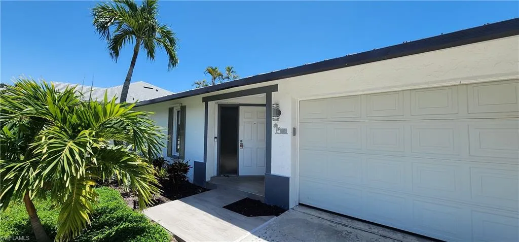 Doorway to property featuring a garage
