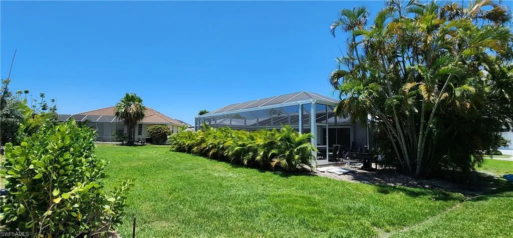 View of yard with screen enclosure