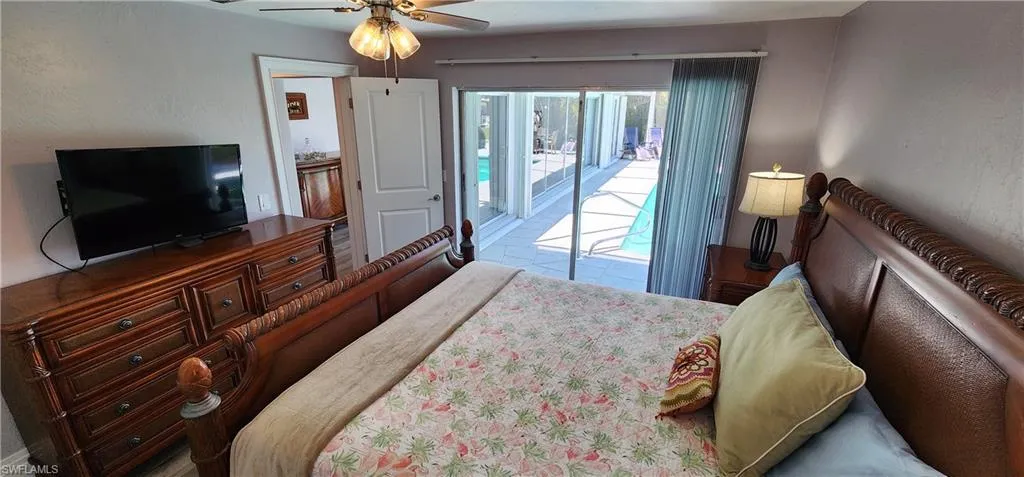 Bedroom with ceiling fan and access to outside