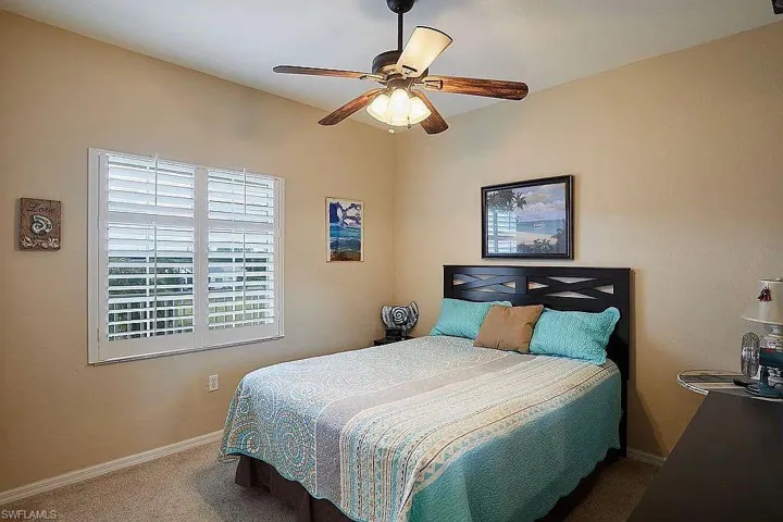 Bedroom with carpet and ceiling fan