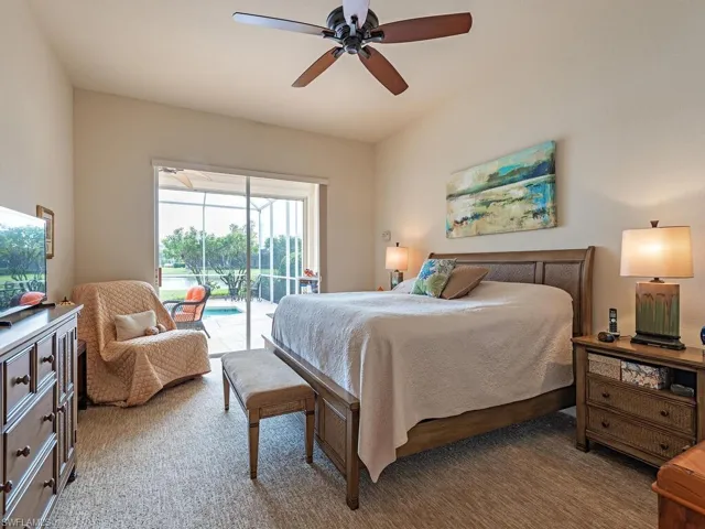 Master Bedroom with access to exterior, carpet floors, and ceiling fan