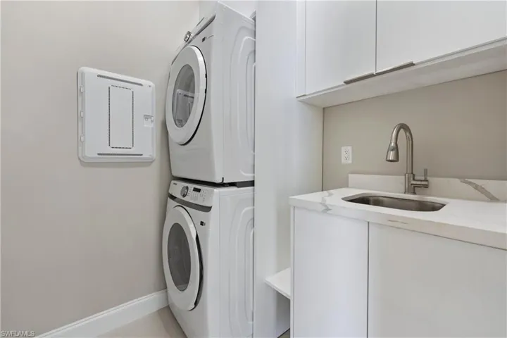 Laundry area with cabinet space and stacked washer / drying machine