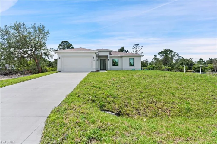 Prairie-style home featuring concrete driveway, a garage, and stucco siding