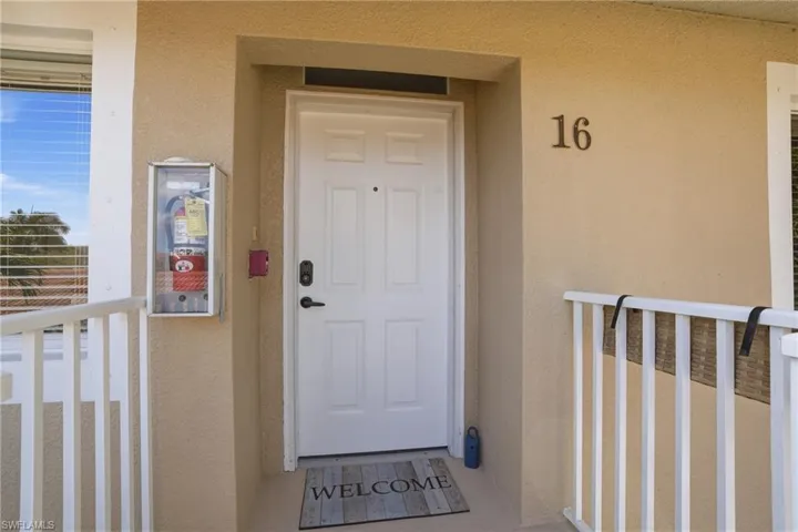 Entrance to property with stucco siding