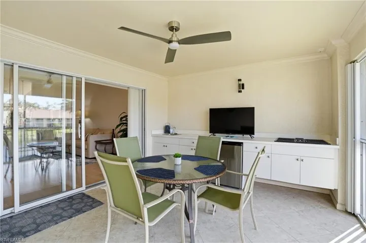 Sunroom featuring ceiling fan, plenty of natural light, and outdoor dining space