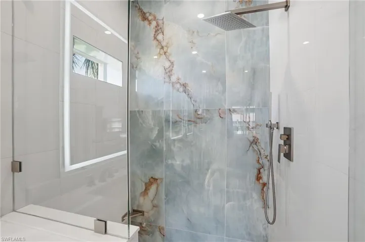 Bathroom with a marble finish shower