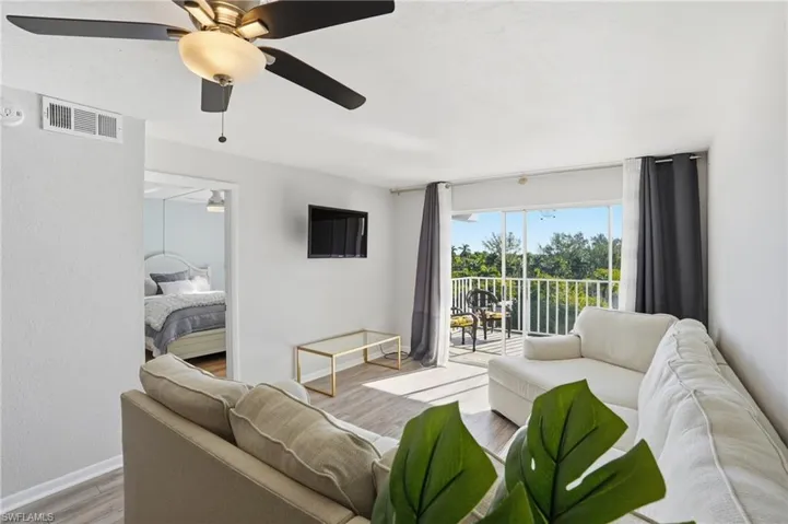 Living room featuring wood finished floors and a ceiling fan