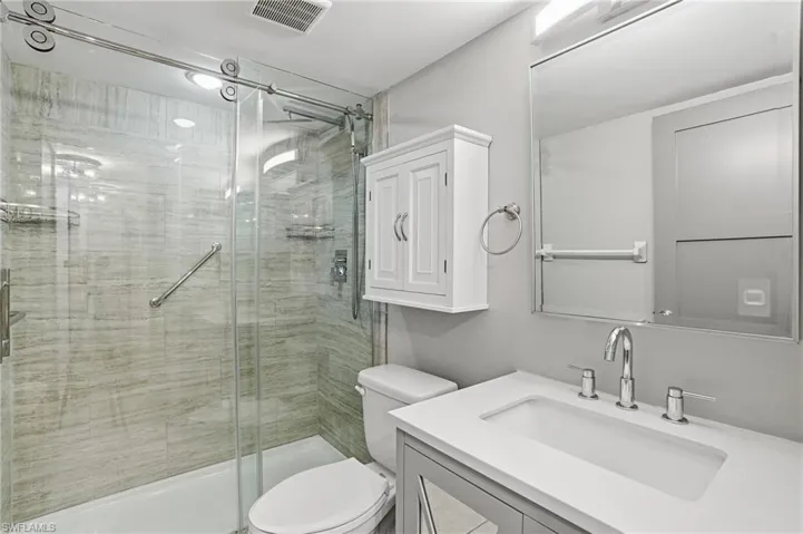 Bathroom featuring vanity and a stall shower