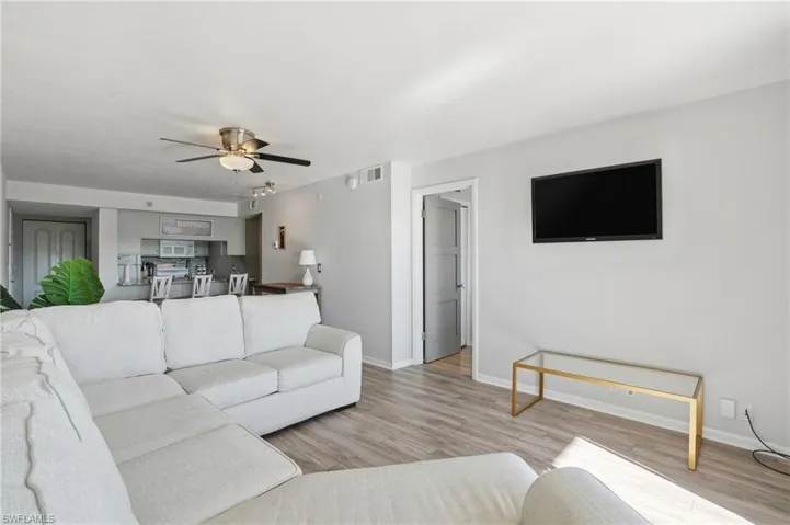 Living area featuring a ceiling fan and light wood finished floors
