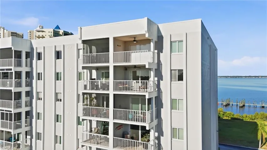 View of apartment building / complex featuring a water view