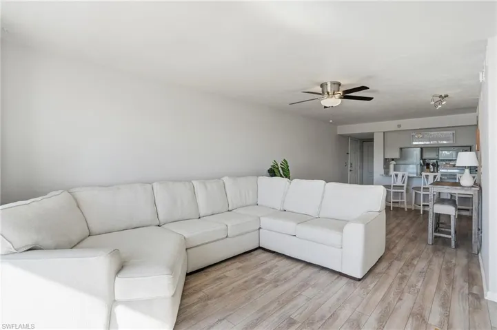 Living area with light wood-style floors and ceiling fan