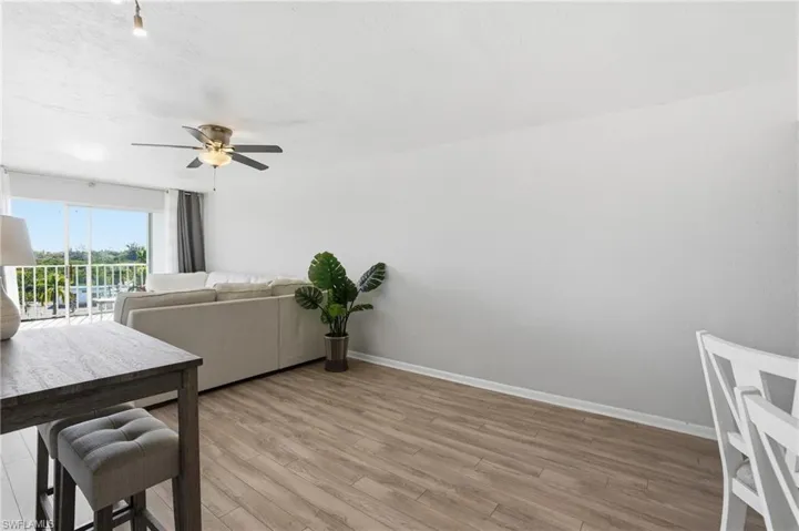 Dining area with light wood finished floors and ceiling fan