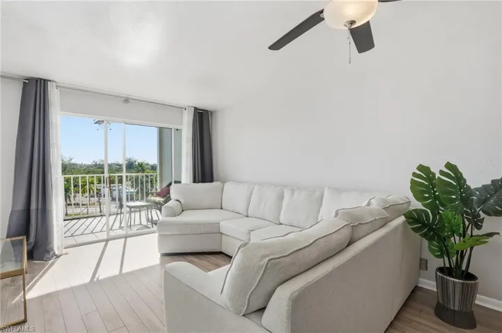 Living room with wood finished floors and ceiling fan